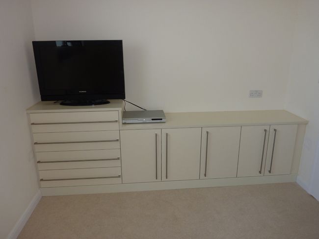 white cupboards with TV on it