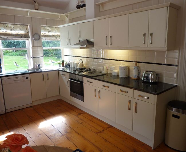 White kitchen cupboards and wooden floor